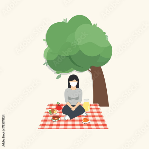 Woman with mask having picnic under tree on checkered blanket.