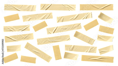 Collection of beige masking tape pieces isolated on black background adhesive paper elements for design and crafts textured strips creative resource