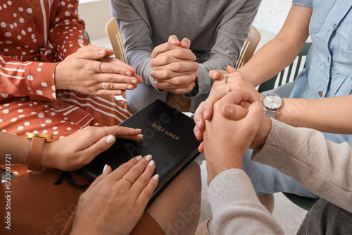 Group of young people prayi...