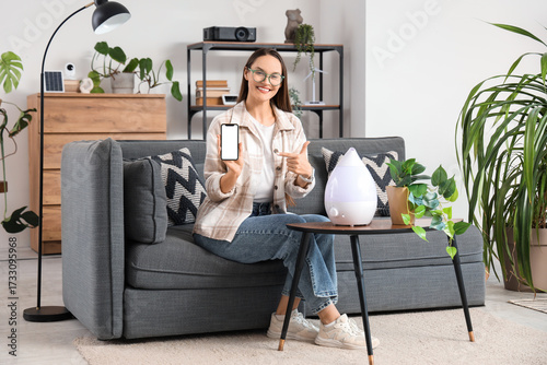 Young woman with blank mobi...