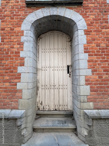 White door and stone archway