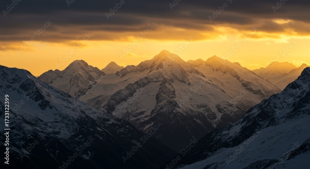 Fototapeta premium Mountain peaks glowing at sunset with snow