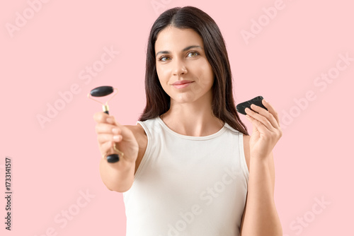Young woman with facial mas...