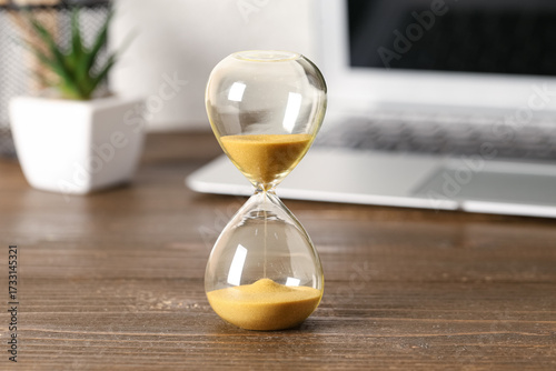Hourglass and laptop on tab...