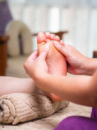 Close up of therapist massaging foot for relaxation and wellness.