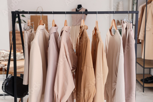 Rack with stylish clothes a...