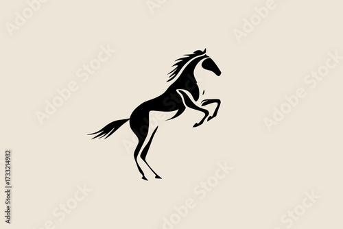 Dynamic black silhouette of a powerful horse rearing up on its hind legs, showcasing strength and freedom, on a neutral background.