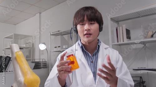 Young male Asian doctor explains and advises patient medicines with remote telemedicine, online wireless technology, pharmacy prescribes consultation via internet webcam, and healthcare call center.