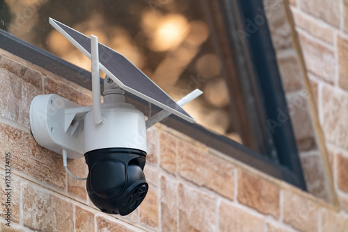 Solar powered wireless security camera on country house wall