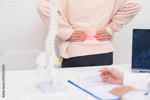Elderly Patient consulting Doctor with Spine anatomy for Spinal Cord Disorder and disease, Back pain, Lumbar, Sacral pelvis, Cervical neck, Thoracic, Coccyx, Orthopedist, chiropractic, Office Syndrome