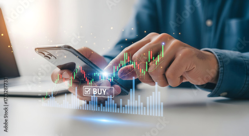 Man trading stocks online with a smartphone app showing stock market data