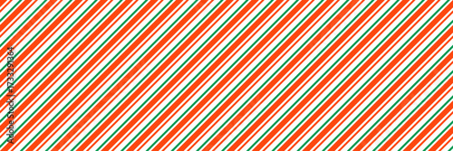 Green and red Christmas seamless pattern. Xmas diagonal stripes wallpaper. Candy cane peppermint repeating background. Winter holiday present wrapping paper design. Vector line decoration backdrop