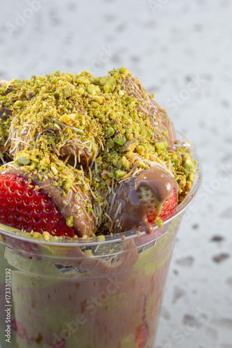 Photography A closeup view of a cup of Dubai strawberry chocolate dessert cup