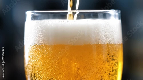 Wallpaper Mural Close up of golden beer pouring into chilled glass with bubbles rising and foam forming on top, creating refreshing and vibrant macro scene in cool ambient lighting Torontodigital.ca