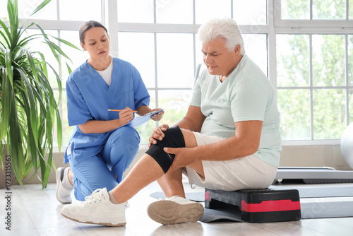 Senior man with knee pain a...