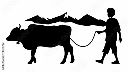 Boy gently guiding his cow through majestic mountain landscape