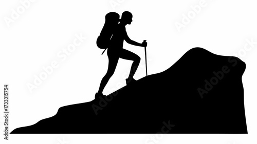 Determined hiker ascends rugged mountain peak using trekking pole for support and balance