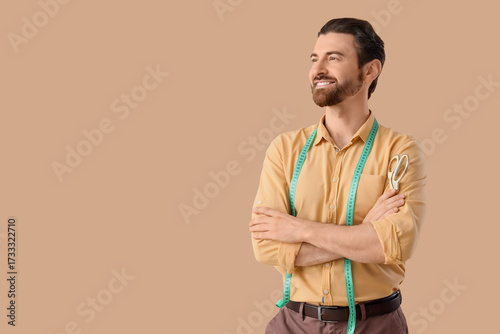 Male tailor with tape measu...