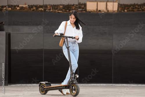 Young businesswoman riding ...