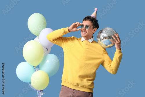 Happy young man with disco ...