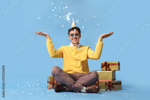 Happy young man with gifts ...