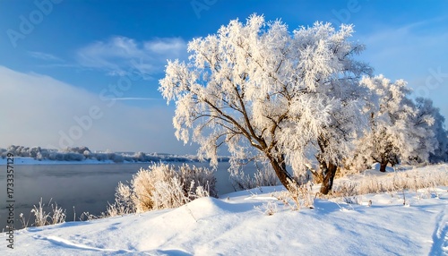 Snowy landscape with frosted trees by a serene river under a bright blue sky