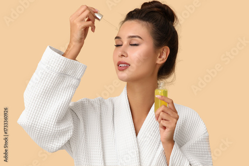 Young woman in bathrobe app...