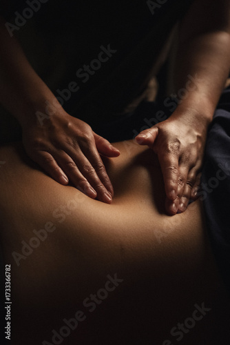 Close-up of hands performing relaxing massage therapy in a spa setting. Manual body treatment for stress relief, relaxation, and holistic wellness.