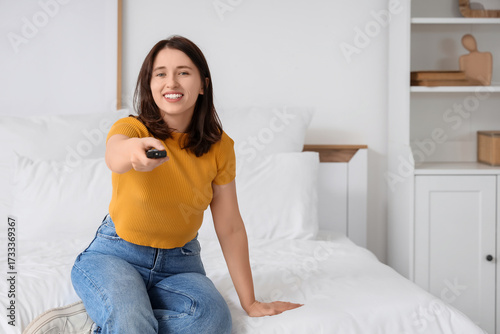 Young woman with remote con...