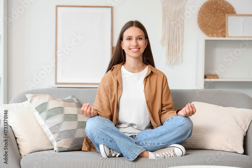 Young woman meditating on s...