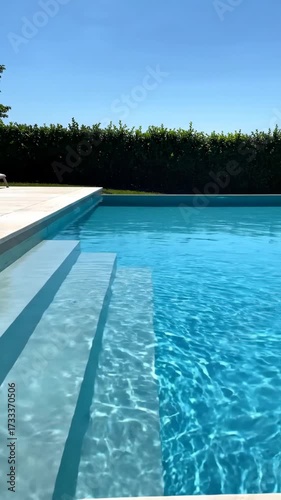 Close Up View of Swimming Pool Steps and Water in Summer