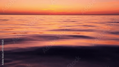 Wallpaper Mural Serene ocean sunset with vibrant orange sky reflecting on gentle waves. Torontodigital.ca
