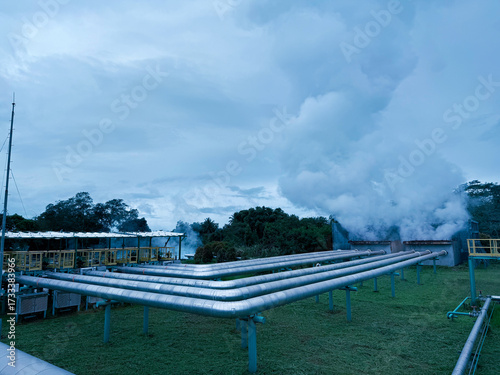 Geothermal power plant in North Sulawesi, Indonesia with steam, energy, power generation. Industrial architecture in landscape, renewable industry, sustainable energy.