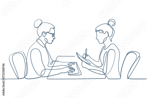 Two women in a meeting one typing and the other taking notes