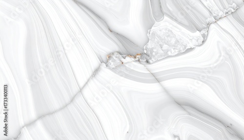 A close-up of a white and gray marbled surface with gold veins and cracks