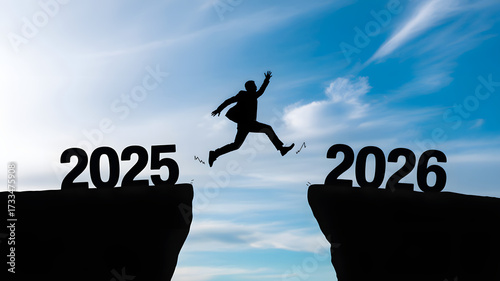 Welcome merry Christmas and happy new year in 2026,Silhouette Man jumping from 2025 cliff to 2026 cliff with cloud blue sky and sunlight