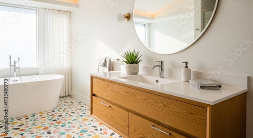 Bright bathroom interior with colorful tiled floor, oval mirror, wood cabinet