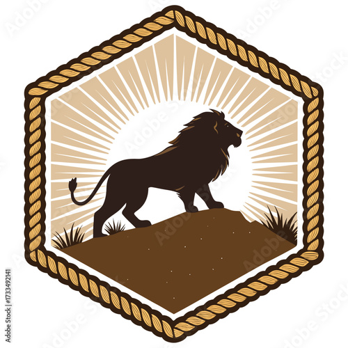 A dark brown lion stands on a hill with sun rays behind it.