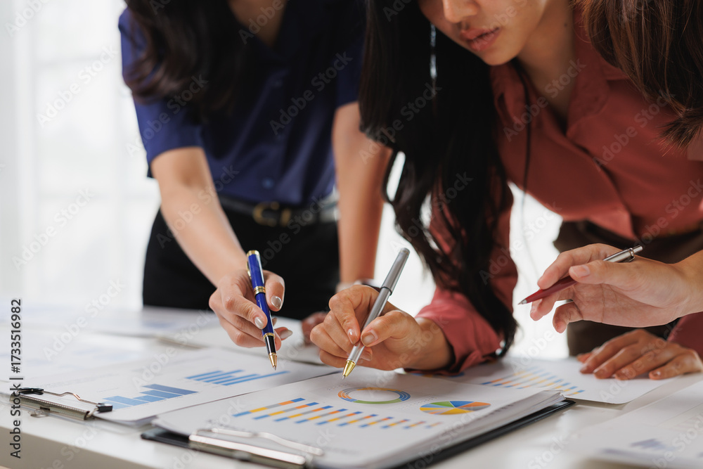Fototapeta premium Businesswomen analyzing financial charts and statistics in office meeting