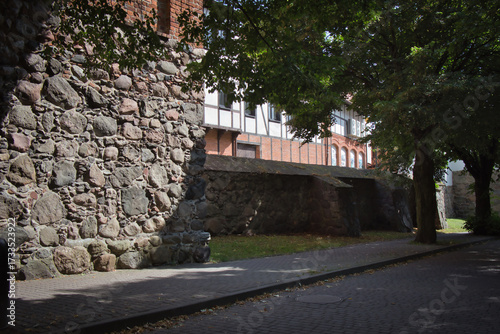 A stone wall with a stone bench in front of it