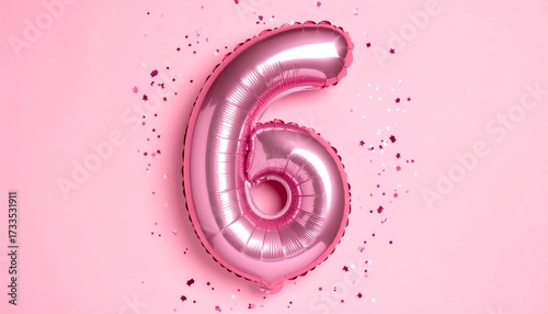 Pink balloon number 6 with confetti on solid colored background. Photo for anniversary or birthday party