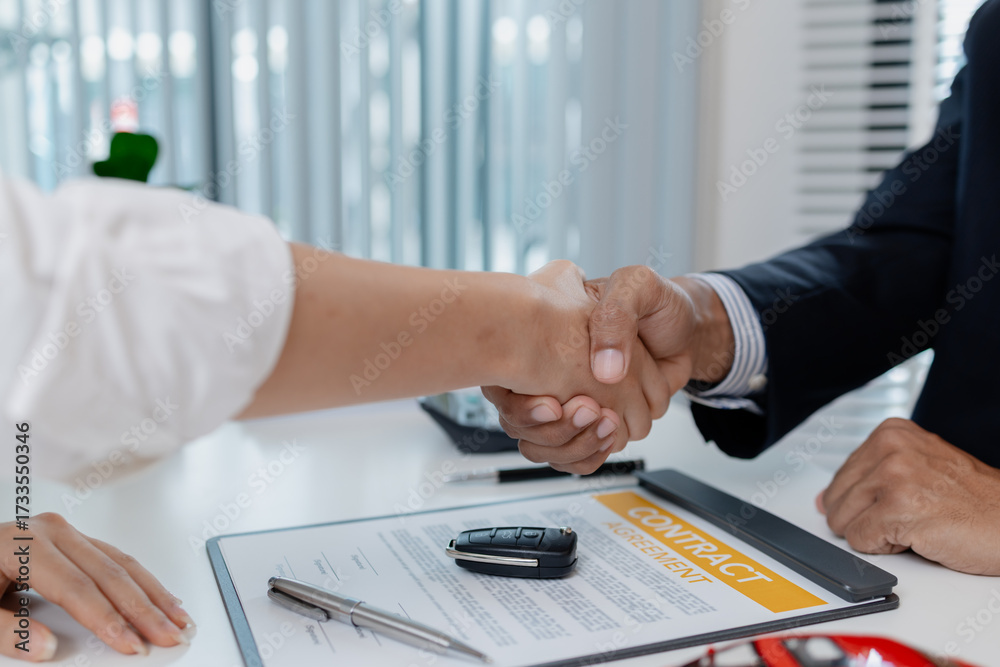 Fototapeta premium A professional car sales process showing contract signing, financial discussion, key handover, and handshake between client and dealer, symbolizing trust, agreement, and successful deal.