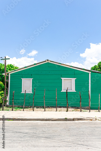 Pedernales, Dominican Republic, 8 august 2025. Typical Dominican Caribbean house made of wood, painted a bright green color.