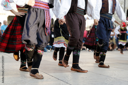 Dancers dancing and wearing one of the traditional folk costume from Uzide, Serbia