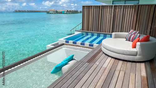 Foto A private overwater deck featuring a circular sofa, plunge pool and hanging net