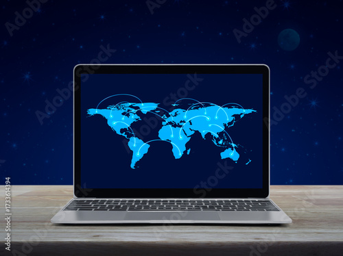 Connection line with global world map on laptop computer monitor screen on wooden table over fantasy night sky and moon, Business communication online concept, Elements of this image furnished by NASA
