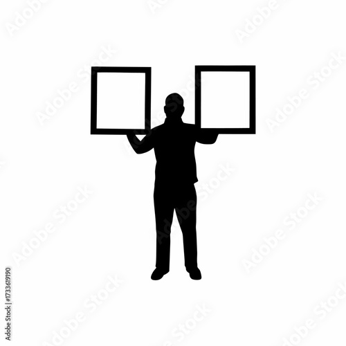 Silhouette of craft seller arranging framed artworks on white background isolated on white background