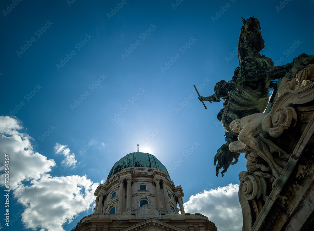 Obraz premium Dome of Royal Palace and equestrian statue against blue sky