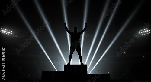 Silhouette of person celebrating victory under stage lights arms raised in triumph