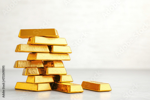 Gold bars stacked on light surface reflect recent plunge in gold prices creating sense of financial uncertainty
